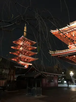 a chinese building with a clock tower at night at bnb+ Asakusa Kuramae in Tokyo