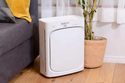 a white trash can sitting next to a couch at Suiren Residential Suite Tokyo in Tokyo