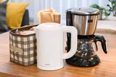 two coffeemakers sitting on a table next to a box at Suiren Residential Suite Tokyo in Tokyo