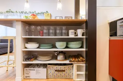 a shelf filled with dishes and plates in a kitchen at Suiren Residential Suite Tokyo in Tokyo