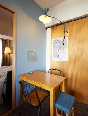 a room with a table and two chairs and a bed at Shibuya apartment SHINSEN in Tokyo