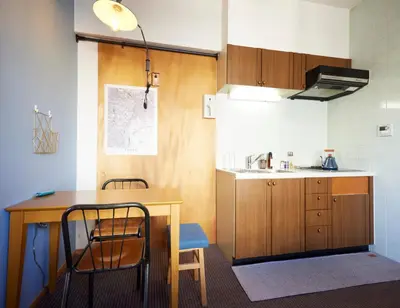 a kitchen with a wooden table and a table and chairs at Shibuya apartment SHINSEN in Tokyo