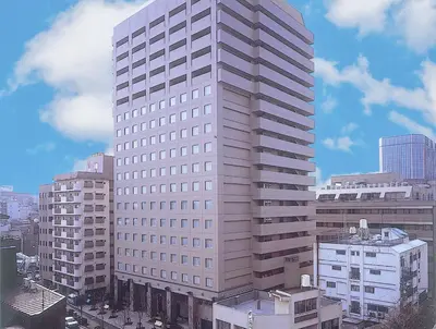 a tall white building in a city with buildings at HOTEL MYSTAYS PREMIER Omori in Tokyo