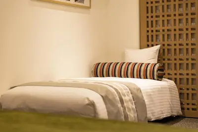 a bedroom with a bed and a chair at HOTEL MYSTAYS PREMIER Omori in Tokyo