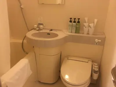 a small bathroom with a sink and a toilet at Chisun Inn Keikyu Kamata in Tokyo