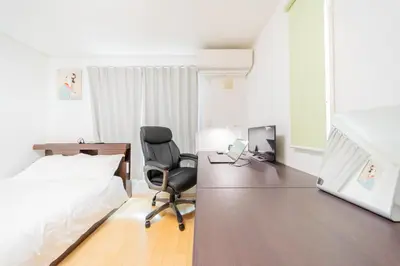 a bedroom with a bed and a desk and a chair at Tokyo Private House \u5927\u585a\u306e\u5bbf in Tokyo