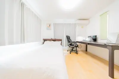 a white bedroom with a desk and a bed at Tokyo Private House \u5927\u585a\u306e\u5bbf in Tokyo