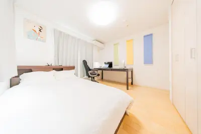 a white bedroom with a bed and a desk at Tokyo Private House \u5927\u585a\u306e\u5bbf in Tokyo