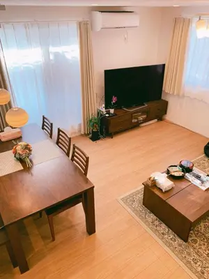 a living room with two tables and a flat screen tv at Uhome Ikebukuro Villa 2 in Tokyo