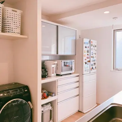 a kitchen with white cabinets and a refrigerator at Uhome Ikebukuro Villa 2 in Tokyo