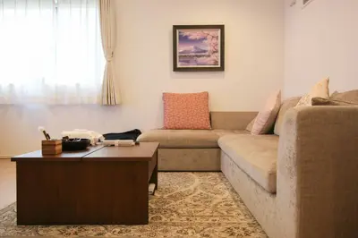 a living room with a couch and a coffee table at Uhome Ikebukuro Villa 2 in Tokyo