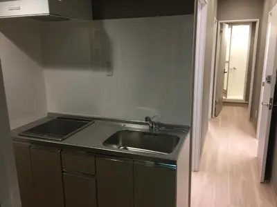 a kitchen with a sink and a counter top at Yushima Okachimachi Hotel in Tokyo