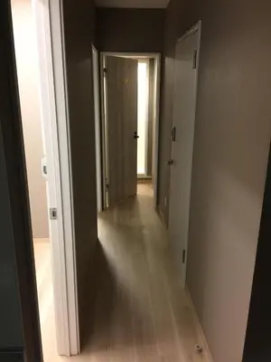 an empty hallway with a hallway leading to a door at Yushima Okachimachi Hotel in Tokyo