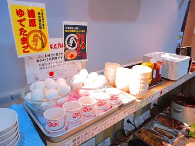 a counter with eggs and other food items on it at Kamata Inn Social in Tokyo