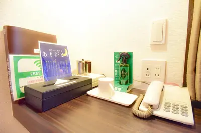 a desk with a fax machine and a telephone at Kamata Inn Social in Tokyo