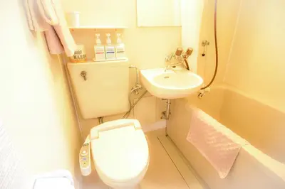 a small bathroom with a toilet and a sink at Kamata Inn Social in Tokyo