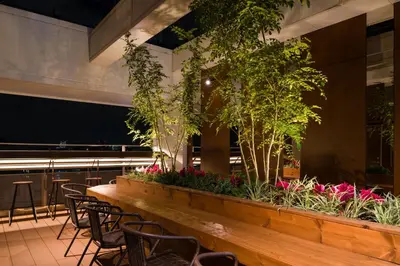 a long table with chairs and plants in a restaurant at Tosei Hotel Cocone Ueno in Tokyo