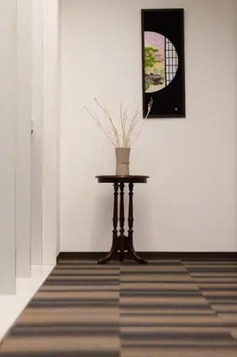 a table with a vase on it in a room at Tosei Hotel Cocone Ueno in Tokyo