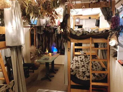 a room with a bunk bed and a table and a desk at TOP EDGE HOSTEL Koenji in Tokyo