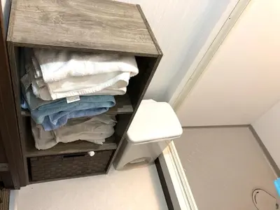 a small cabinet with towels in a bathroom at TOP EDGE HOSTEL Koenji in Tokyo