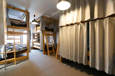 a room with two bunk beds and a room with at TOP EDGE HOSTEL Koenji in Tokyo