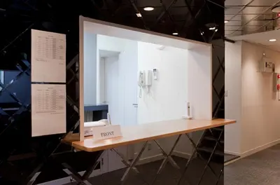 a bathroom with a vanity and a mirror at The Shin-Okubo International Hotel in Tokyo