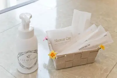 a bottle of sunscreen and a basket of tissues at The Shin-Okubo International Hotel in Tokyo