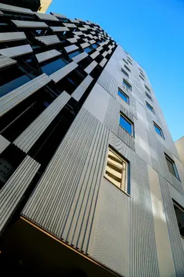 a tall building with a window on the side of it at Hotel Comfact in Tokyo