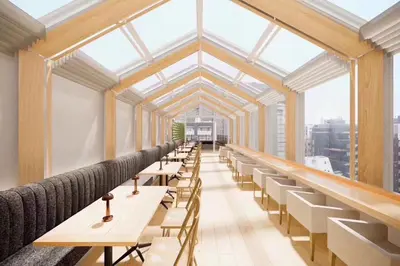 a row of tables and chairs in a room with windows at Hotel Comfact in Tokyo