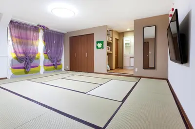a room with a room with a tv and a room with a room at Hanabi Hotel in Tokyo