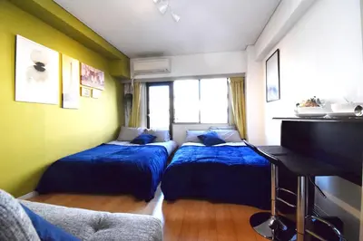 a bedroom with two beds and a piano at LIONS APARTMENT 516 in Tokyo