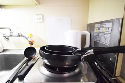 a frying pan sitting on top of a stove at LIONS APARTMENT 516 in Tokyo