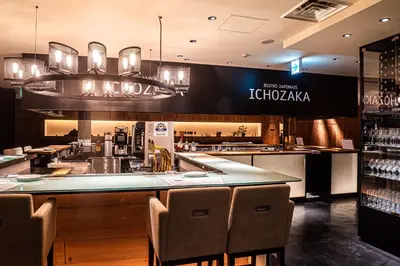 a restaurant with a bar with chairs in front of it at Shinagawa Prince Hotel East Tower in Tokyo