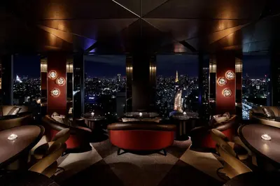 a bar with a view of a city at night at Shinagawa Prince Hotel N Tower in Tokyo