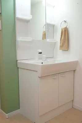 a white bathroom with a sink and a mirror at Blue Empire Hotel in Tokyo