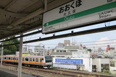 a train on the tracks at a train station at Blue Empire Hotel in Tokyo
