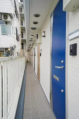a hallway of a hospital with a blue door at Blue Empire Hotel in Tokyo