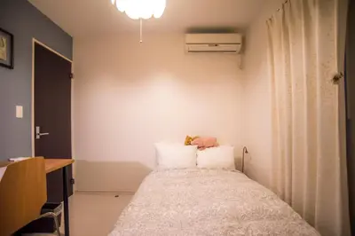 a bedroom with a bed with a teddy bear on it at COCO Shinjuku HOTEL in Tokyo