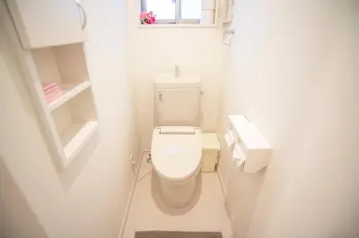 a small white bathroom with a toilet and a window at COCO Shinjuku HOTEL in Tokyo
