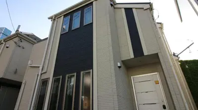 a house with a white door on the side of it at COCO Shinjuku HOTEL in Tokyo