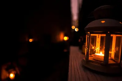 a candle in a lantern on a table at night at COCO Shinjuku HOTEL in Tokyo