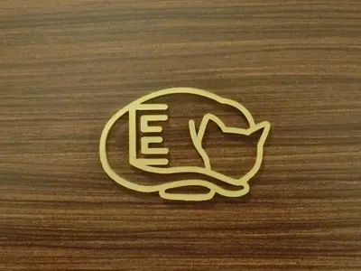 a gold cat logo on a wooden surface at Studio Inn Nishi Shinjuku in Tokyo