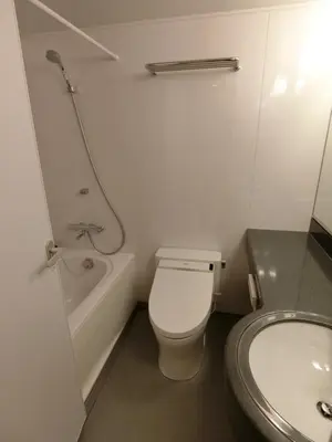 a bathroom with a toilet and a tub and a sink at Studio Inn Nishi Shinjuku in Tokyo