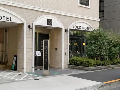 a building with two arches on the side of it at KOKO HOTEL Shimbashi Onarimon - formerly Hotel Wing International Shimbashi Onarimon in Tokyo