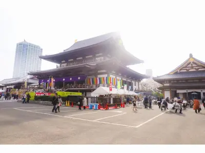 a large building with people walking in front of it at KOKO HOTEL Shimbashi Onarimon - formerly Hotel Wing International Shimbashi Onarimon in Tokyo