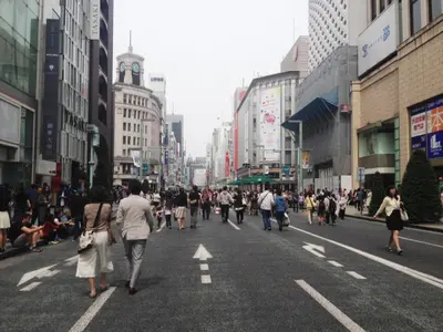 a group of people walking down a busy city street at KOKO HOTEL Shimbashi Onarimon - formerly Hotel Wing International Shimbashi Onarimon in Tokyo