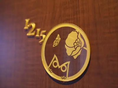 a sign on a wooden wall with a symbol on it at KOKO HOTEL Ikebukuro - formerly Hotel Wing International Select Ikebukuro in Tokyo