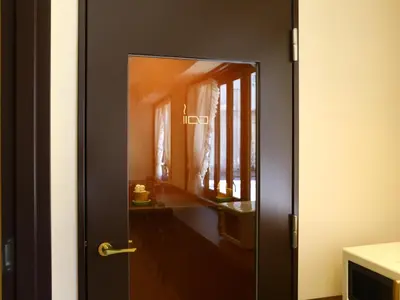 a black door with a window in a room at KOKO HOTEL Ikebukuro - formerly Hotel Wing International Select Ikebukuro in Tokyo