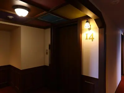 a hallway with a number four light on the wall at KOKO HOTEL Ikebukuro - formerly Hotel Wing International Select Ikebukuro in Tokyo