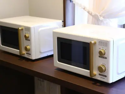 two microwaves sitting on top of a table at KOKO HOTEL Ikebukuro - formerly Hotel Wing International Select Ikebukuro in Tokyo